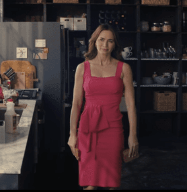 Margaret Fairchild commands attention in a vibrant fuchsia peplum dress, its structured silhouette and bold hue making a sophisticated statement even in a casual setting.